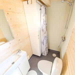 a small bathroom with a toilet and a sink at Nysted Strand Camping & Cottages in Nysted