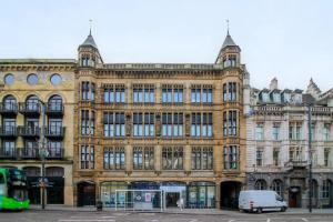 a large building with a van parked in front of it at Stylish Apartment in Leeds City Centre in Central Station