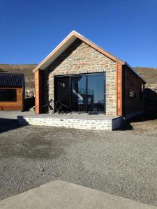 a small building with a large window on it at Simply Stunning Studio 1 in Lake Tekapo