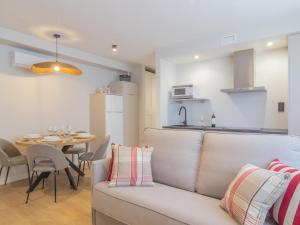 a living room and kitchen with a couch and a table at Apartamento Mar Salada Bocal in Santander