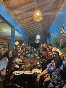 a group of people sitting around a long table at Andamundos Hostel in Mina Clavero