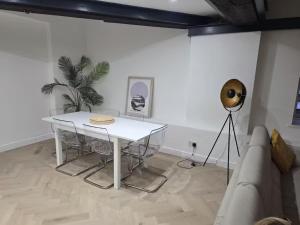 a living room with a white table and a couch at Liverpool Penthouse - Sleeps 8 - City Centre in Liverpool