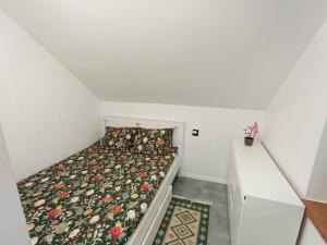 a small bedroom with a bed in a attic at Domek Wrzos in Brenna