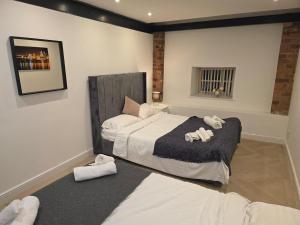 a bedroom with a bed with two towels on it at Liverpool Penthouse - Sleeps 8 - City Centre in Liverpool