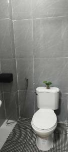 a bathroom with a toilet with a plant on it at Tony's City Centered Budget Room in San Fernando +15 photos