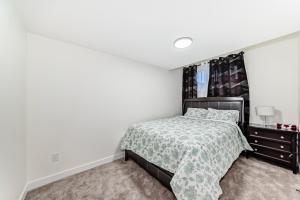 a bedroom with a bed and a window at KimzNest in Edmonton