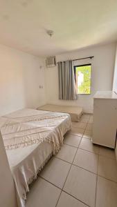 Postel nebo postele na pokoji v ubytování Village Conchas e Corais