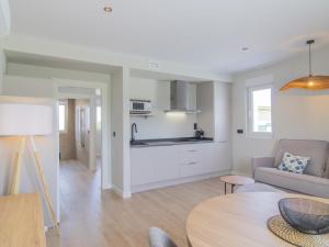 a living room with a couch and a table at Apartamento Mar Salada Piquel in Santander