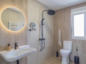 a bathroom with a sink and a toilet and a mirror at Apartamento Mar Salada Piquel in Santander