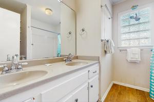 a bathroom with two sinks and a large mirror at No Regrets Down in Emerald Isle +16 photos