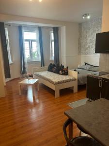 een woonkamer met een bank en een bed bij 1 st may plaza de luxe in Bratislava