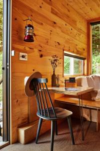 a wooden cabin with a desk and a chair at Postcard Cabins Brazos Valley, Outdoor Collection by Marriott Bonvoy in Navasota