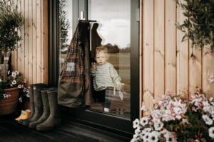 a little child sitting in a window with an umbrella at The Granary Estates 