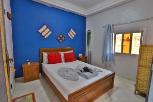 a bedroom with a bed with a blue wall at Blue Rina Hostel in Agadir