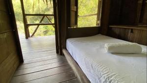 a bedroom with a bed on a wooden porch at Minca Elemento in Minca