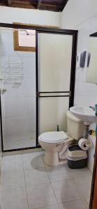 a bathroom with a toilet and a sink at Cabaña La Manuela Coveñas in San Antero