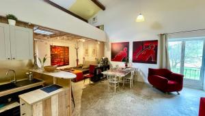 a kitchen and living room with a table and chairs at Authentic & charming dans les Monts du Lyonnais, animaux acceptés in Larajasse