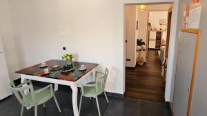 a dining room with a table and green chairs at Lower Floor In Flor do Campo - Santana in Santana