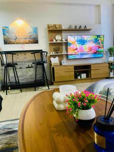 a living room with a table and a tv at Condo Stay Near SM City Santa Rosa Mall in Ibaba