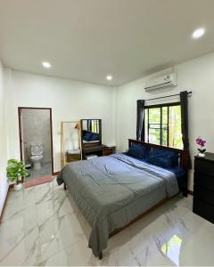 a bedroom with a bed and a desk and a mirror at PoolvillaLana 3 rooms in Bang Sare +26 photos