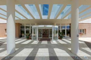 a large building with columns and a glass ceiling at Hotel Centro di Spiritualità Padre Pio in San Giovanni Rotondo