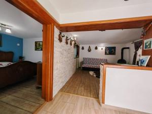 a living room with a brick wall and a couch at Cabana lui Foardă in Motru Sec