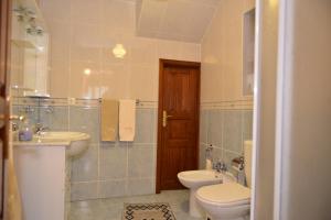 a bathroom with a toilet and a sink at AL Vivenda Romantica Geres in Geres +31 photos
