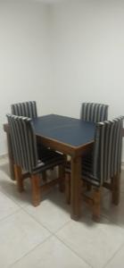 a wooden table with four chairs around it at Departamento nuevo cerca de micro centro 4 in San Luis