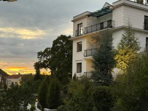 a fire on the side of a white building at Vila Maister in Celje