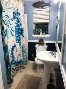 a bathroom with a toilet and a sink at Cozy Gulf Coast Getaway in Pensacola