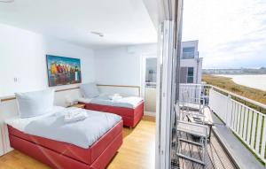 a room with two beds and a balcony at Schleikante in Olpenitzdorf