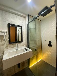 a bathroom with a sink and a glass shower at Inti Paqari in Arequipa