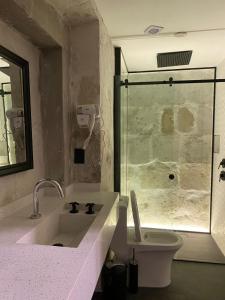 a bathroom with a sink and a glass shower at Inti Paqari in Arequipa +22 photos