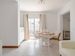a white dining room with a table and chairs at Villa Ocean 8 by Dreaming Lanzarote Villas in Yaiza