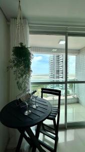 a table and chairs in a room with a window at (1001) Vista Mar Perto das Praias in Vinhais