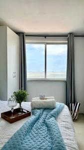 a bedroom with a large bed with a large window at (1001) Vista Mar Perto das Praias in Vinhais