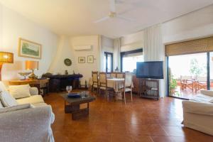 a living room with a couch and a tv at Villa Soliva - Mare e Panorama Unico in Mondello