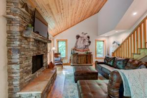 a living room with a stone fireplace and a couch at Paws A While in Blowing Rock