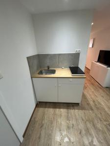 a bathroom with a sink in a room at Le Loft Minimal in Huy