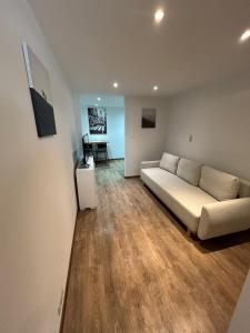 a living room with a couch and a table at Le Loft Minimal in Huy