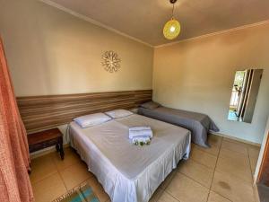 une chambre avec deux lits avec des serviettes dessus dans l'établissement Pousada Gaia Canastra, à São João Batista do Glória