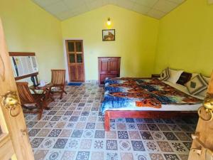 a bedroom with a large bed in a room at Ranthambhore Bagh Dwar Camp in Khilchipur