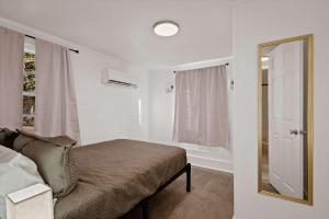 a bedroom with a bed and a mirror and a window at Blue Ox in Pensacola