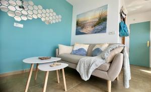 a living room with a couch and a table at Beachside Living in Spain s Sunniest Coast Sleeps 2 Guests Ruselo R408 in Torrox Costa