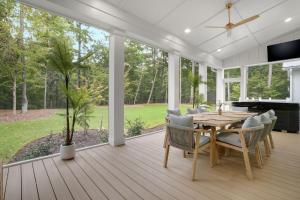 a dining room with a table and chairs at Creekside - Custom Luxury in Bay Creek Resort! in Cape Charles