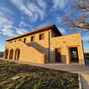 a large brick building with a large door at Agriturismo Giorgini in Marsciano