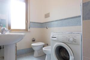 a bathroom with a washing machine and a toilet at Villa Soliva - Mare e Panorama Unico in Mondello +24 photos