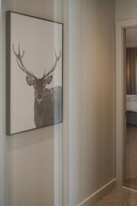 a picture of a deer hanging on a wall at Private luxury Room -B, King bed, Full Ensuite, Free Shuttle to ski hill and Resort in Mont-Tremblant