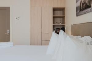 a bedroom with two beds with white pillows at Private luxury Room -B, King bed, Full Ensuite, Free Shuttle to ski hill and Resort in Mont-Tremblant