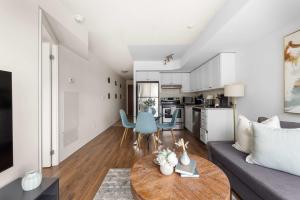 a living room with a couch and a table at Stylish 1BR Condo Near Toronto Top Attractions in Toronto +19 photos